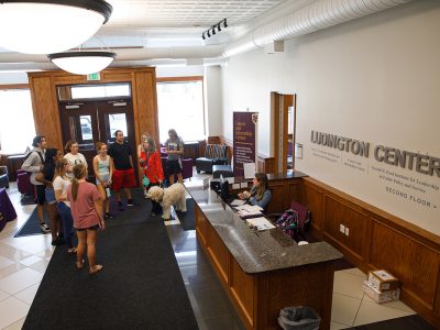 Students inside the lobby of the Ludington Center next to a sign for the Career and Internship Center.