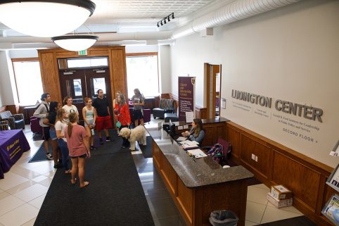 Students inside the lobby of the Ludington Center next to a sign for the Career and Internship Center.