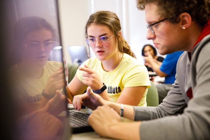 Two students working at a computer.